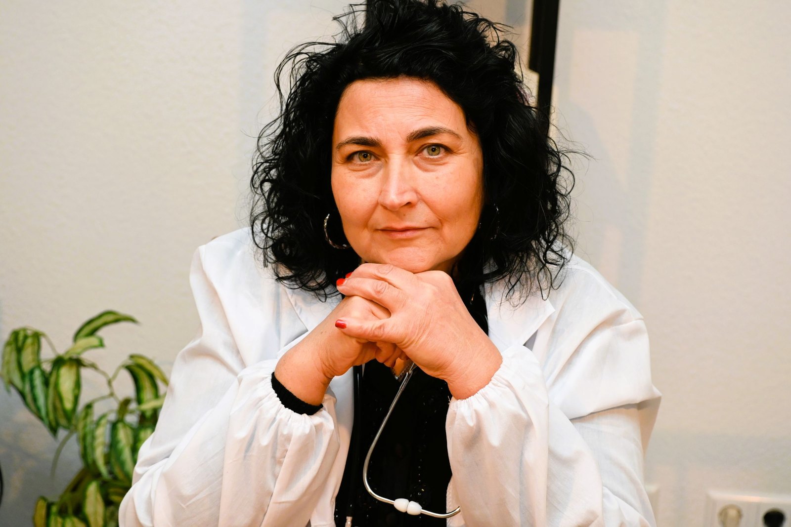 A clinician in a white coat with a stethoscope