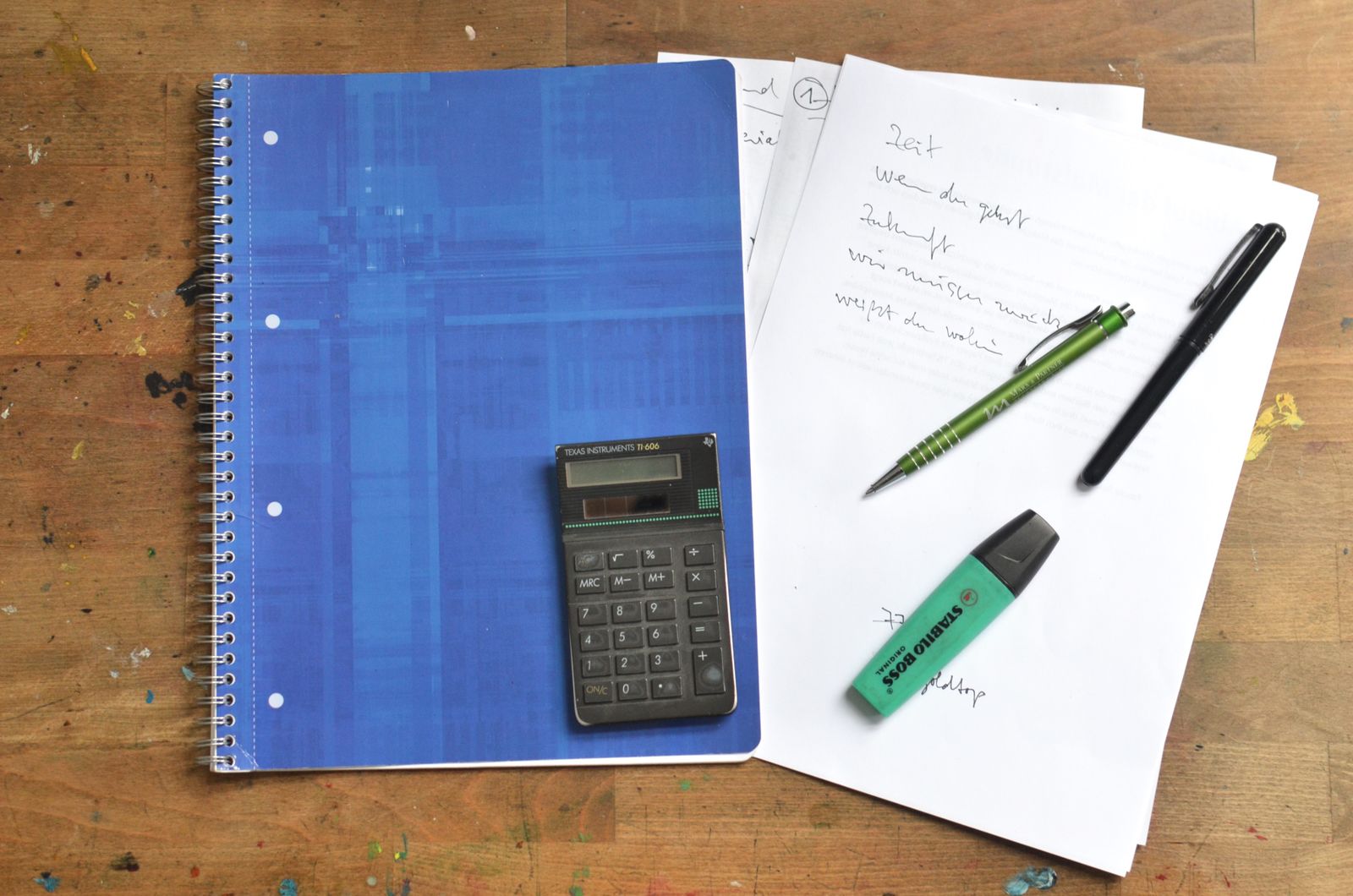 A notebook and planning materials arranged on a desk