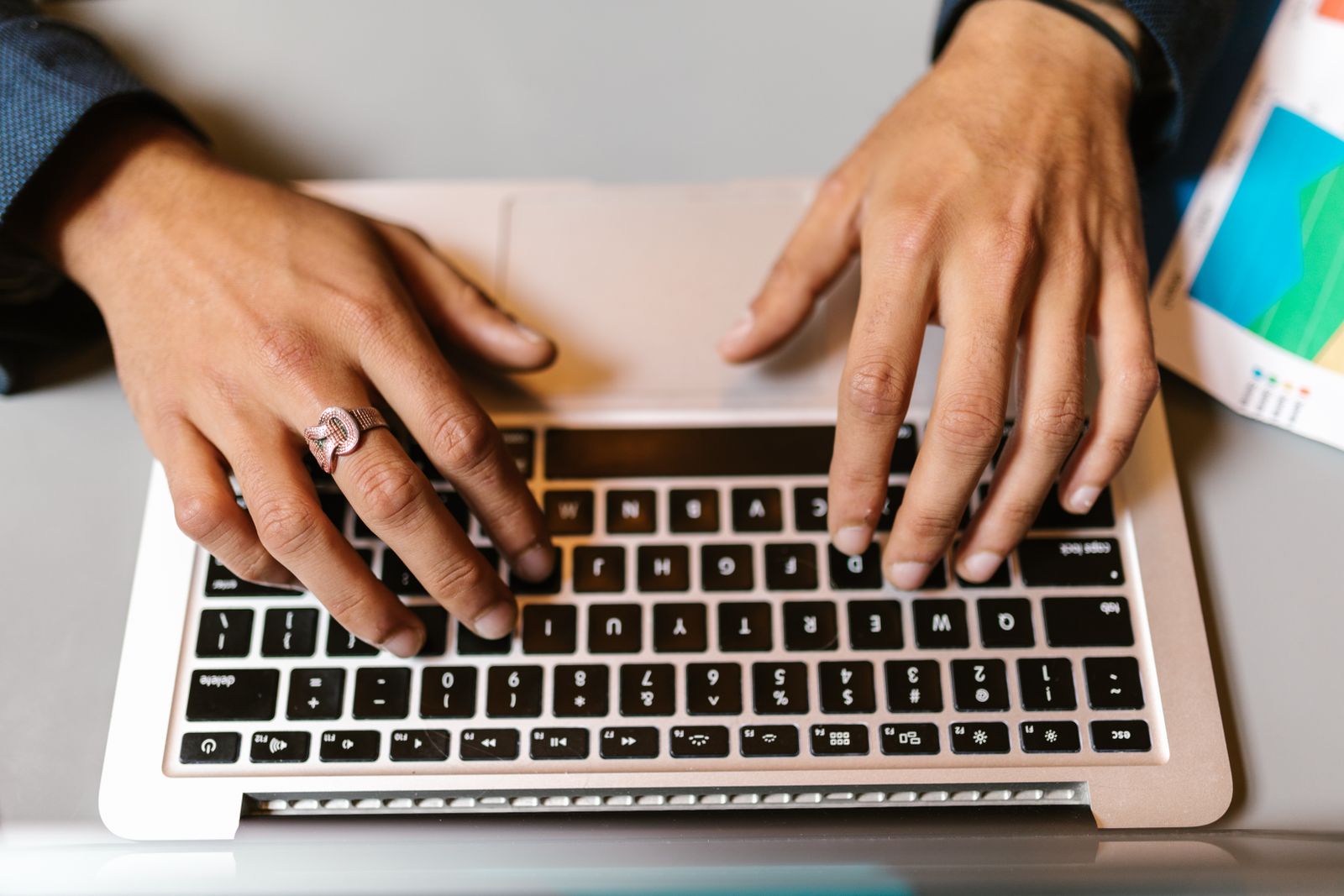 Hands using a personal laptop