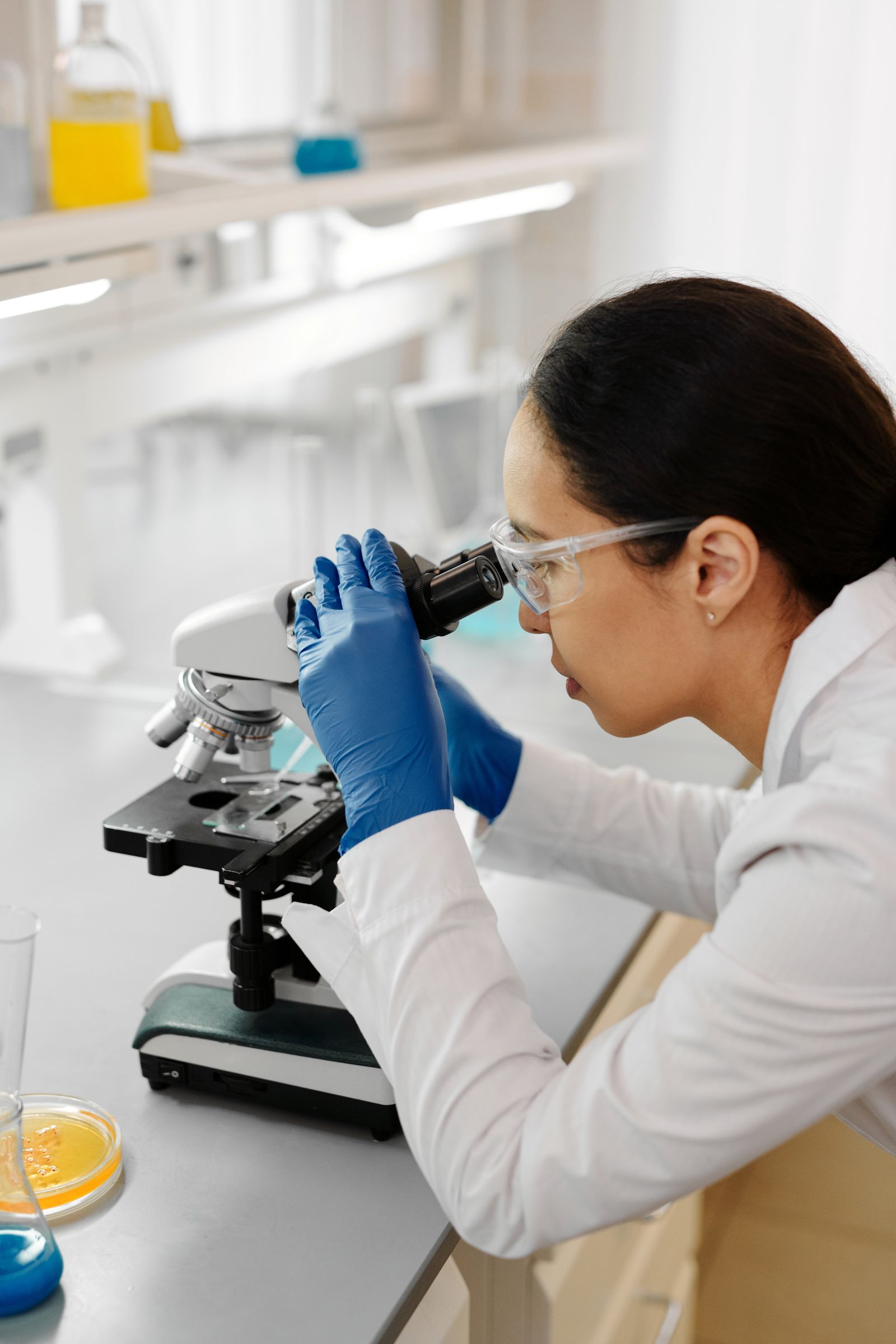 A researcher examining a sample with a microscope