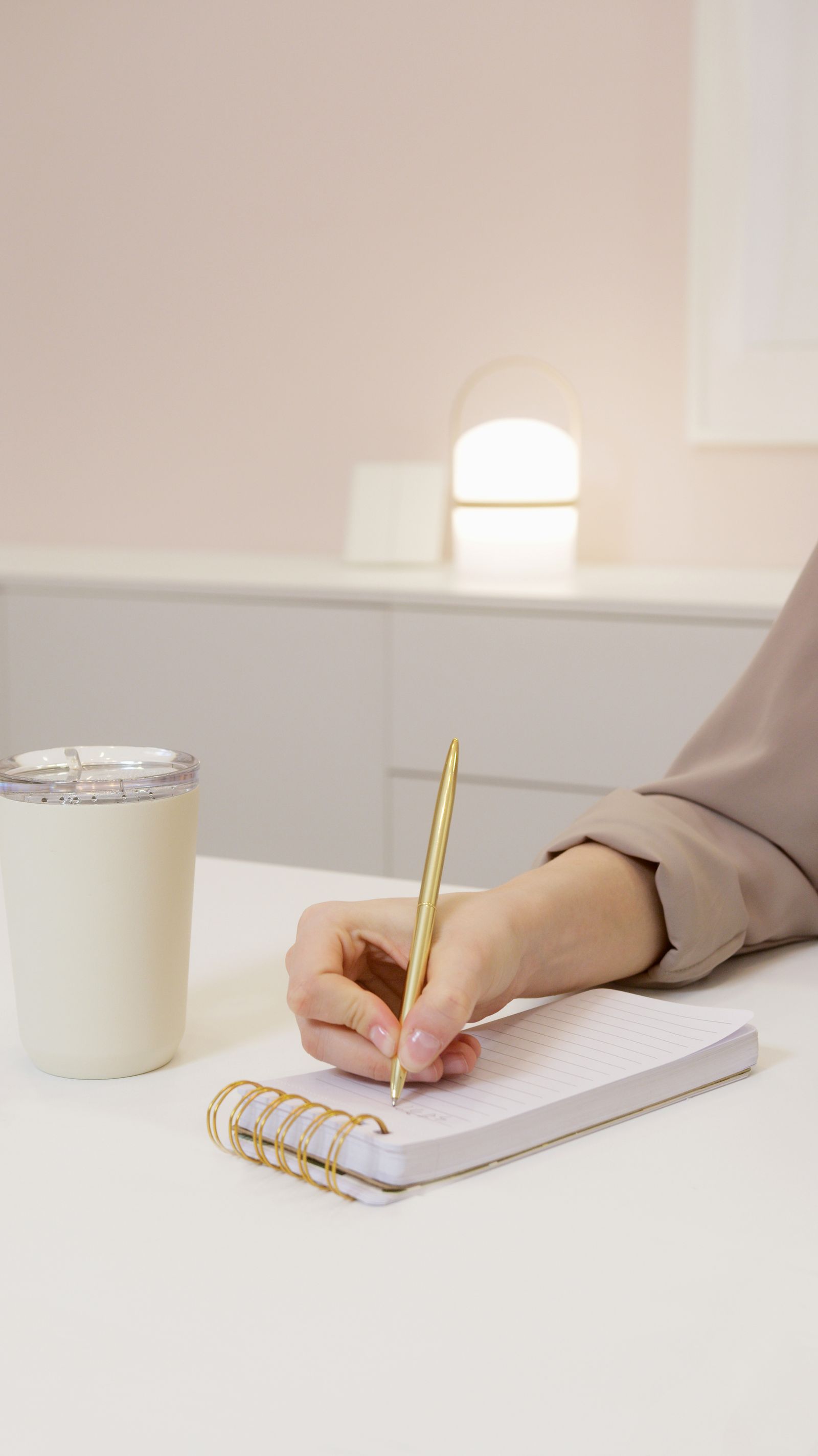 A person reviewing notes with a pen at a desk