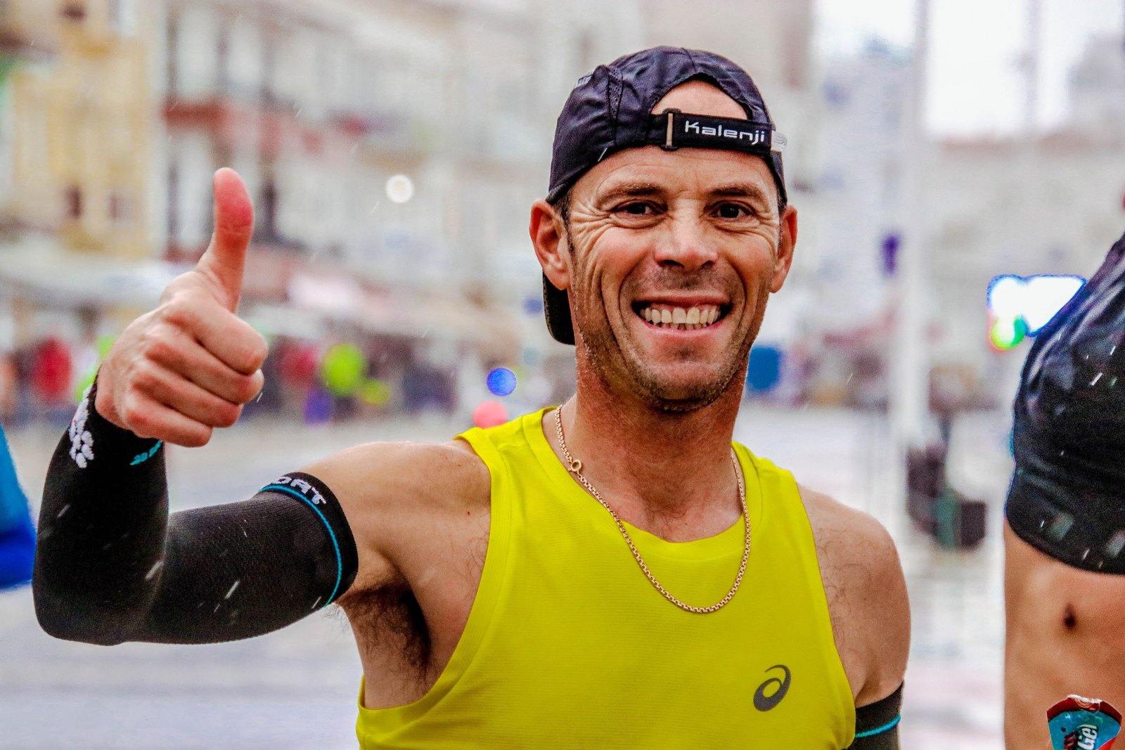A road runner at a city race giving a thumbs-up