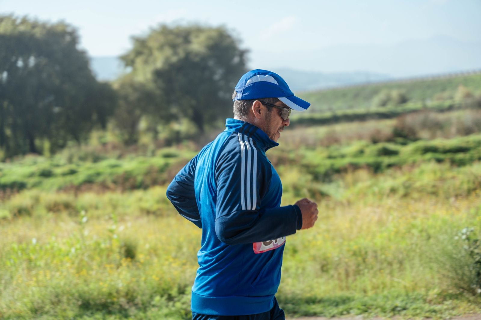 An adult running outdoors